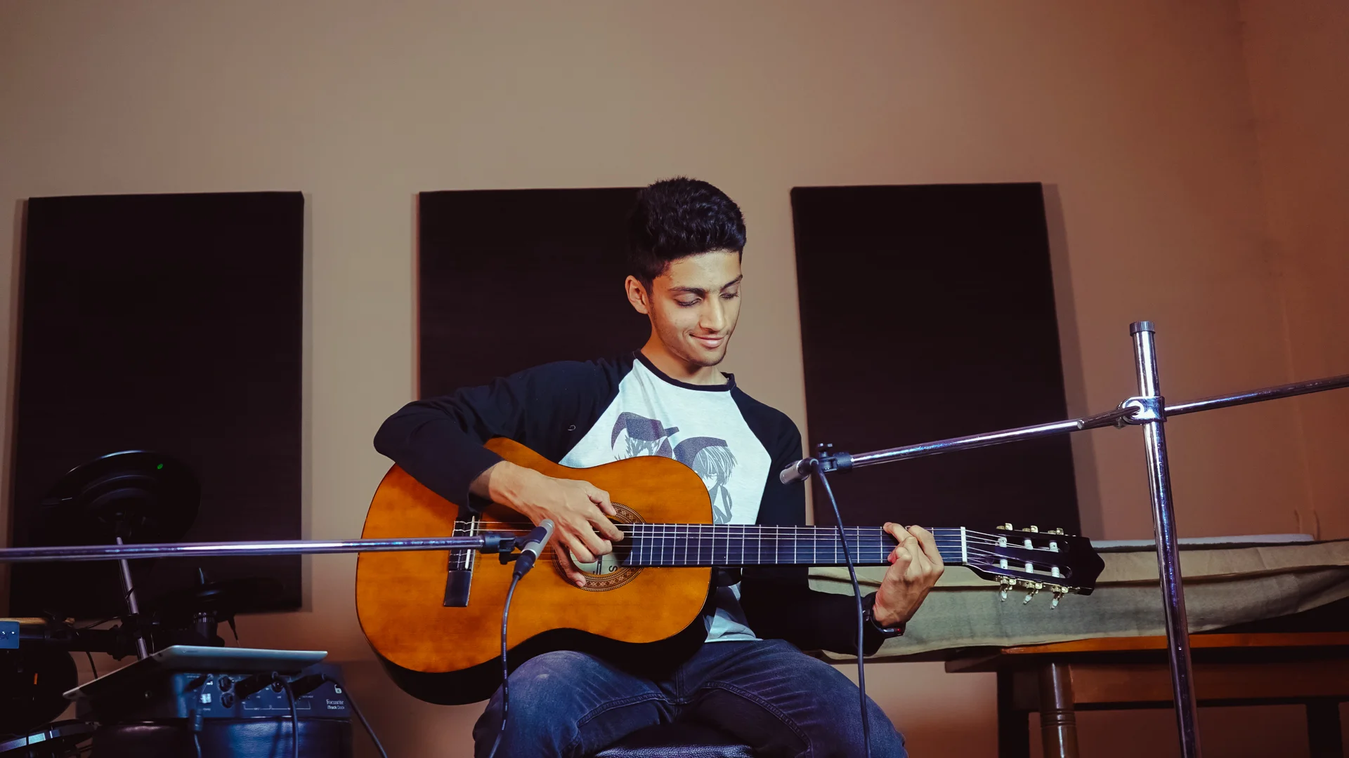 FSG guitar student recording in the exam room — classical guitar, acoustic panels, professional microphone setup