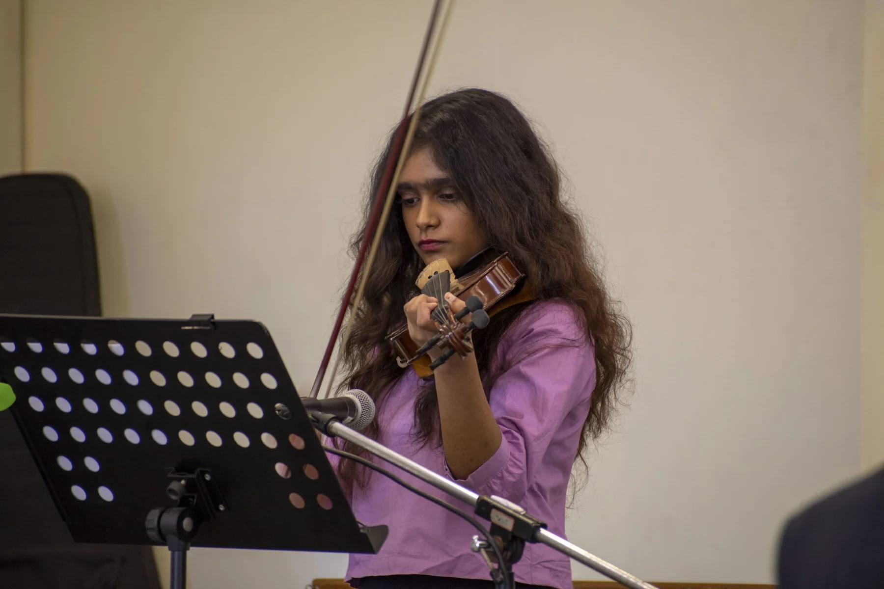 Violin student performing on stage at KMC, Bangalore