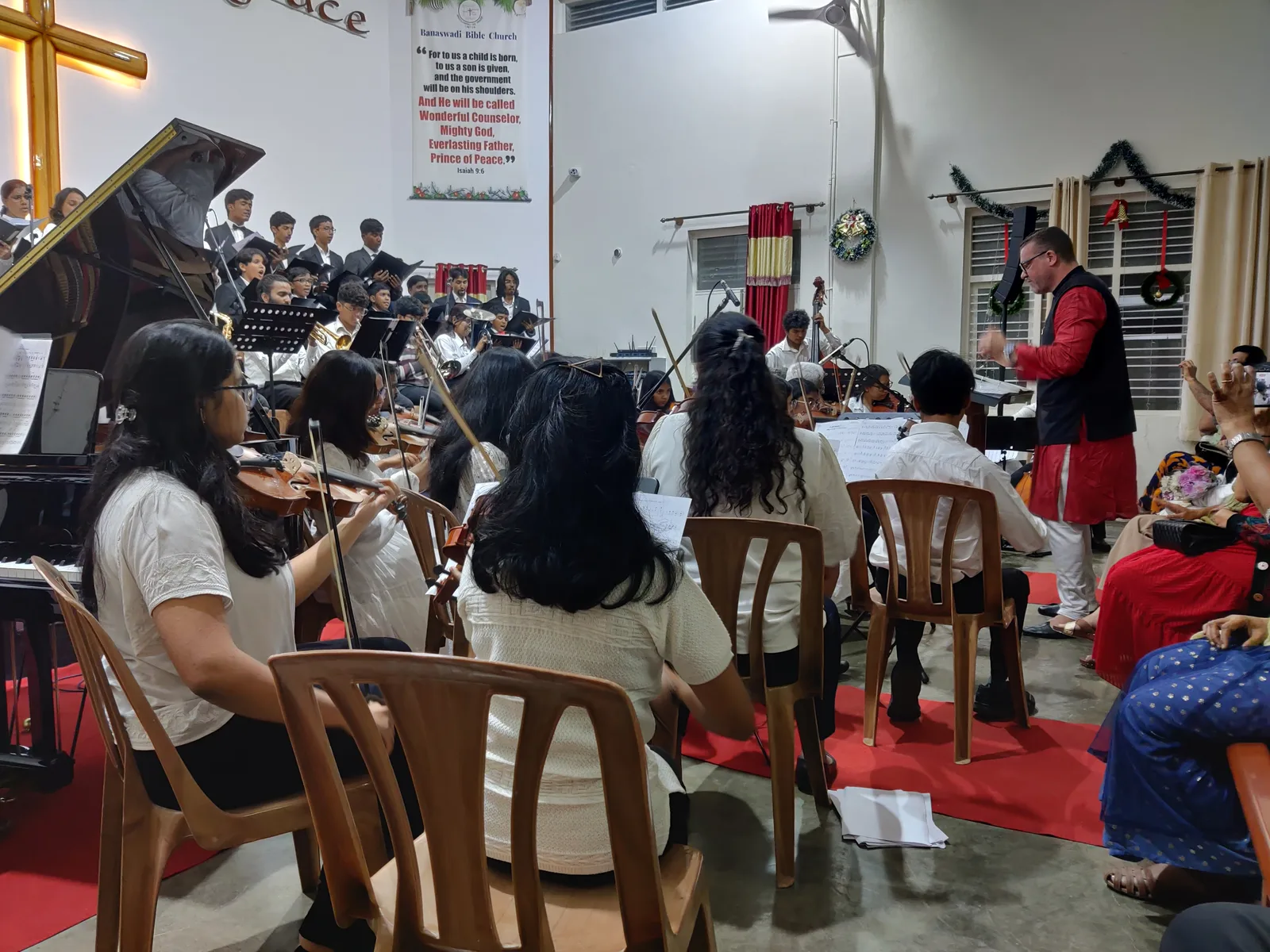 Jonas Olsson conducting the Fingersmith Collective choir and orchestra at Banaswadi Bible Church, December 2024