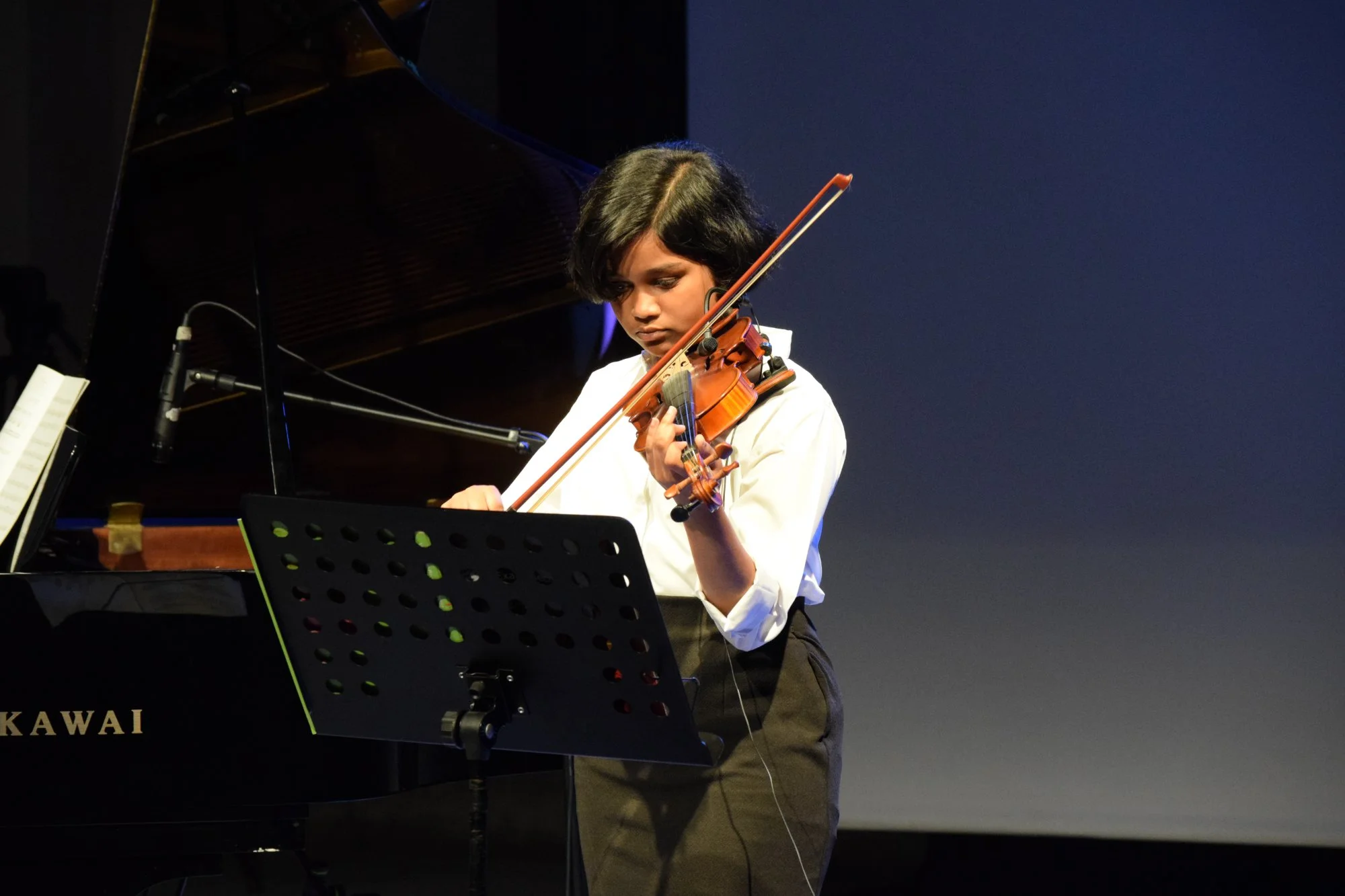 Young violin student solo performance at annual recital